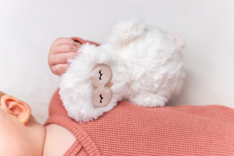 A baby holding a plushie